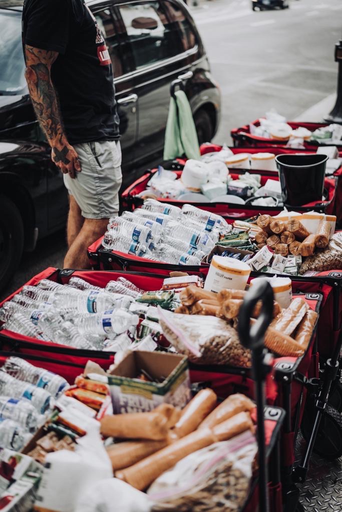 Red carts filled with supplies such as water bottles, crackers, and toilet paper.